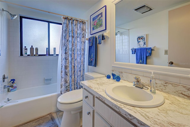 full bathroom featuring toilet, shower / bathtub combination with curtain, vanity, and tile patterned floors