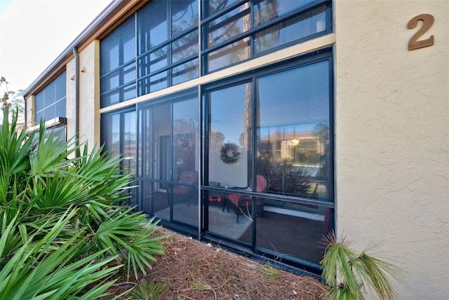 view of side of property featuring a sunroom