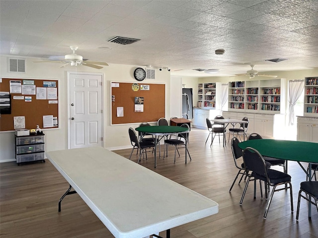 dining space with hardwood / wood-style floors and ceiling fan