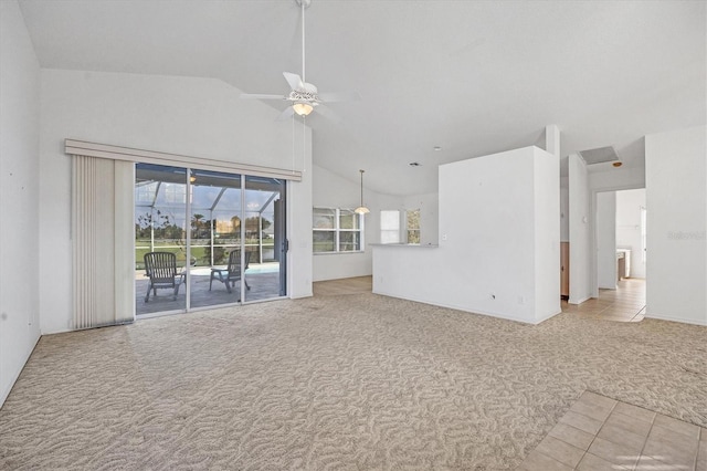 unfurnished living room featuring light carpet, high vaulted ceiling, and ceiling fan