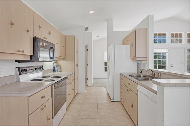 kitchen with lofted ceiling, light brown cabinets, light tile patterned flooring, sink, and white appliances