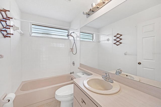 full bathroom with vanity, tiled shower / bath combo, toilet, and plenty of natural light