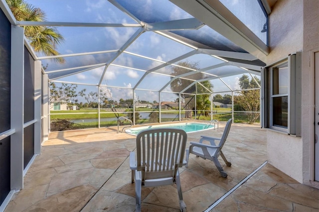 view of patio featuring a water view and glass enclosure