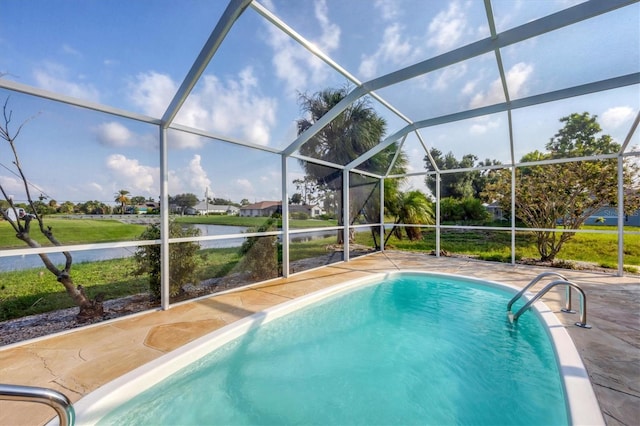 view of swimming pool featuring a water view, a patio area, and glass enclosure