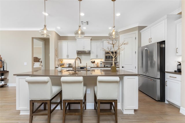 13077 Rinella St, Venice, FL 34293 - kitchen with high quality fridge, dark countertops, backsplash, ornamental molding, and white cabinetry