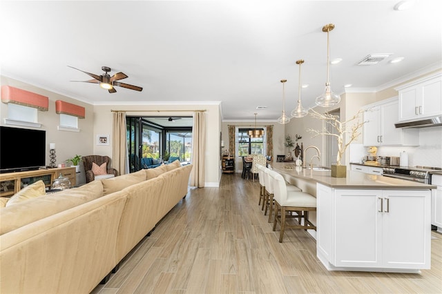 13077 Rinella St, Venice, FL 34293 - living area featuring ornamental molding, a ceiling fan, light wood finished floors, and recessed lighting