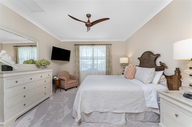 carpeted bedroom with ceiling fan and crown molding