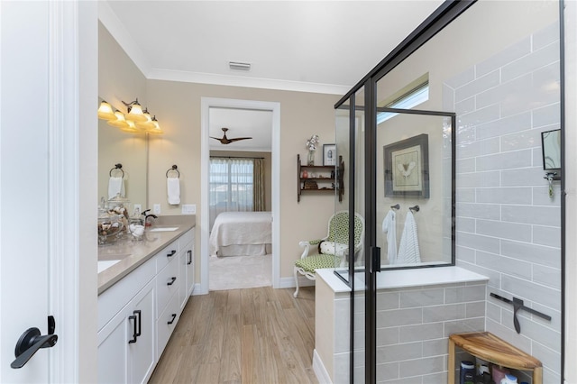 bathroom with ceiling fan, walk in shower, wood-type flooring, vanity, and crown molding