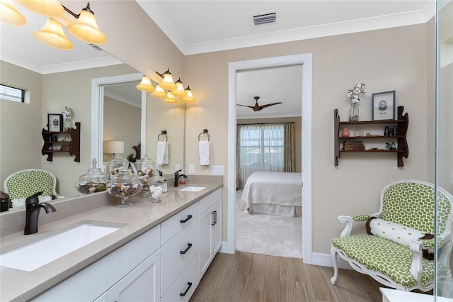 bathroom with vanity, ornamental molding, wood-type flooring, and ceiling fan