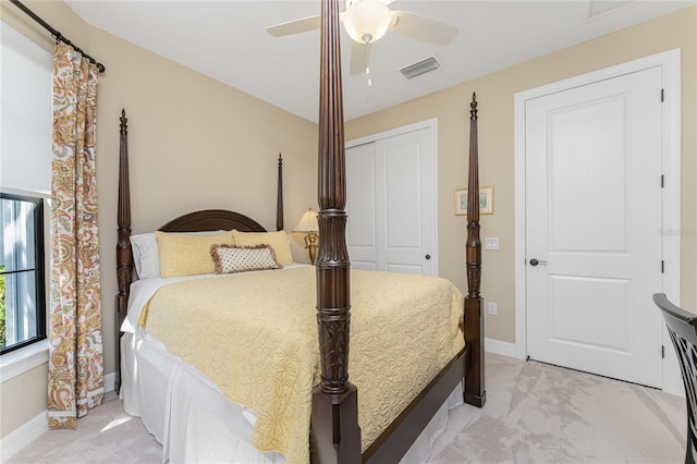 bedroom with light carpet, a closet, and ceiling fan