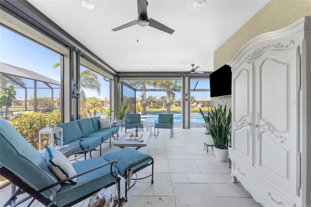 sunroom featuring ceiling fan