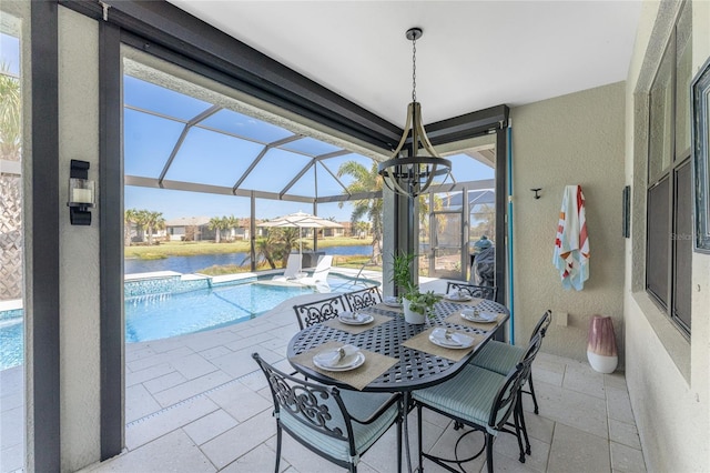 view of patio featuring a water view and glass enclosure