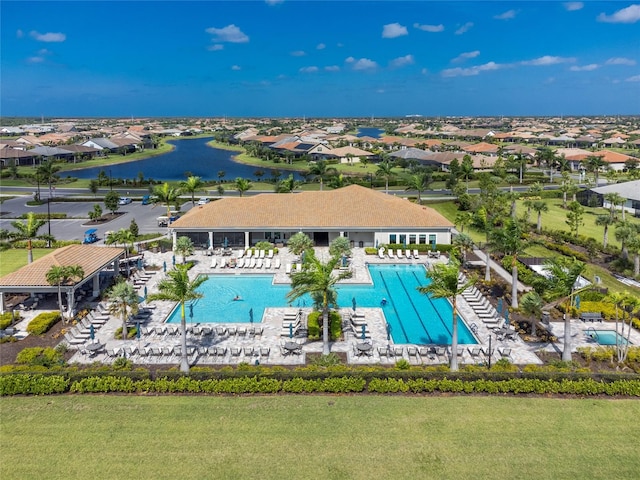 view of pool featuring a patio area and a water view