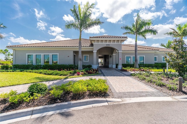 mediterranean / spanish-style house with a carport