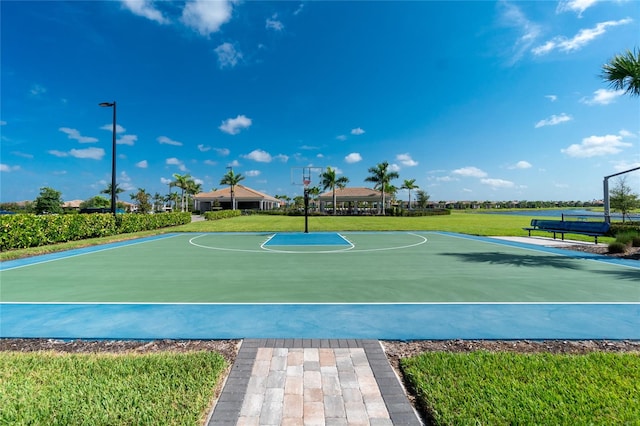 view of sport court featuring a yard