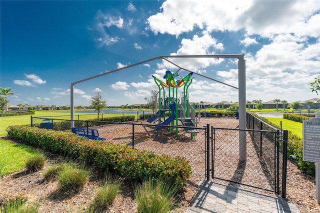 view of play area featuring a water view and a lawn