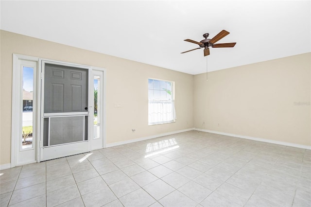 tiled entrance foyer featuring ceiling fan