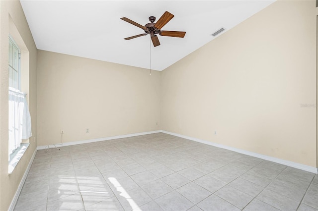 tiled spare room with ceiling fan