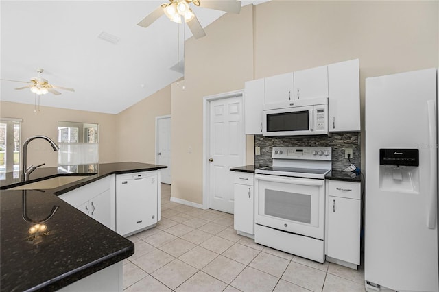 kitchen with white appliances, sink, white cabinets, high vaulted ceiling, and light tile patterned floors