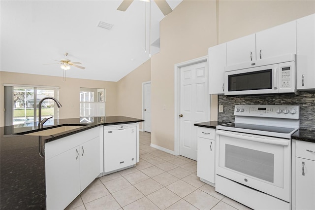 kitchen with white appliances, high vaulted ceiling, sink, and white cabinets