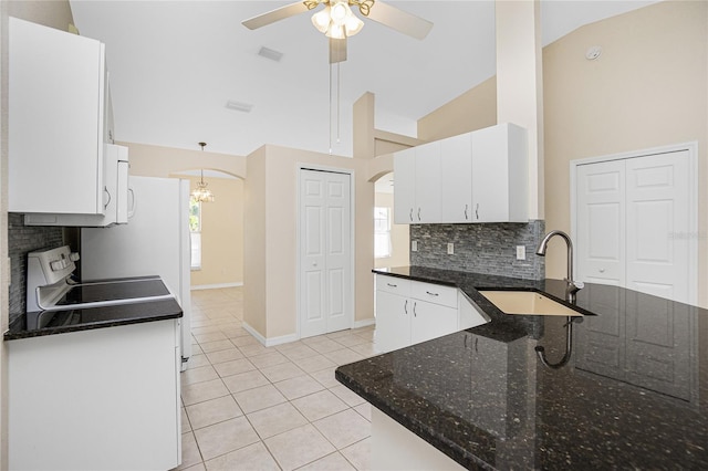 kitchen featuring white cabinetry, light tile patterned floors, high vaulted ceiling, and sink