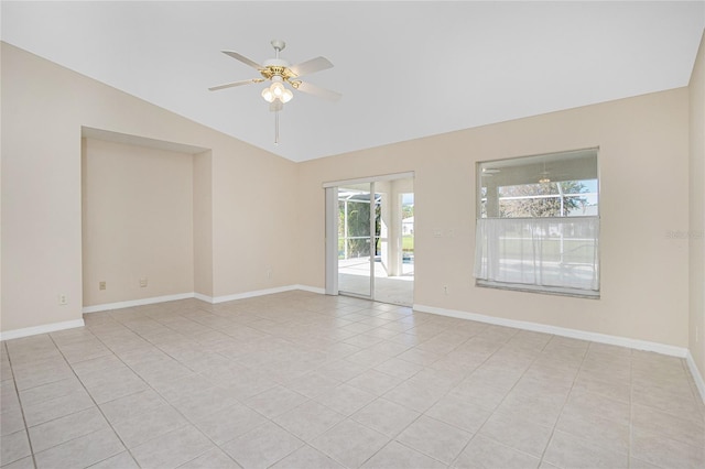 empty room featuring ceiling fan, lofted ceiling, and light tile patterned floors