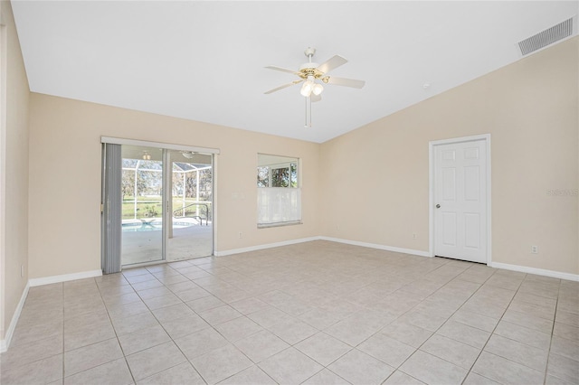 spare room with light tile patterned floors, vaulted ceiling, and ceiling fan