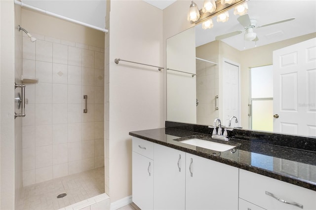 bathroom featuring vanity, ceiling fan, and tiled shower