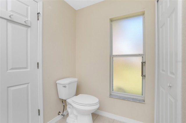 bathroom with toilet and tile patterned flooring