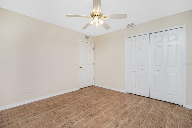 unfurnished bedroom with light hardwood / wood-style floors, a closet, and ceiling fan