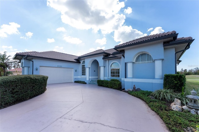 mediterranean / spanish home featuring a garage