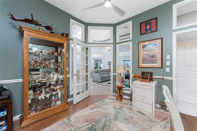 office featuring french doors, ceiling fan, and light wood-type flooring