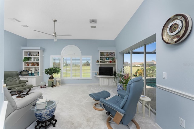 carpeted living room featuring ceiling fan and a wealth of natural light