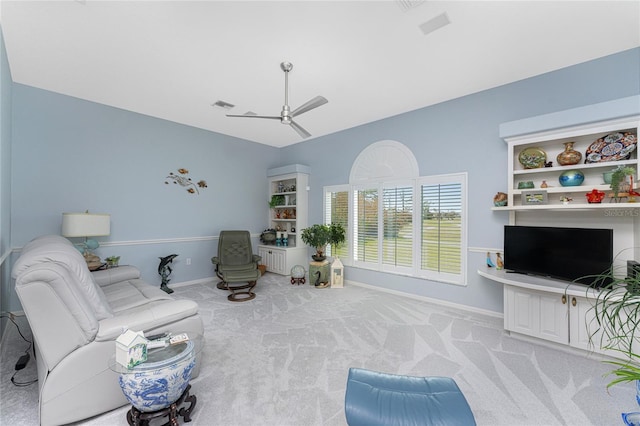 living room with light colored carpet and ceiling fan