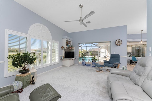 living room featuring carpet, vaulted ceiling, and ceiling fan