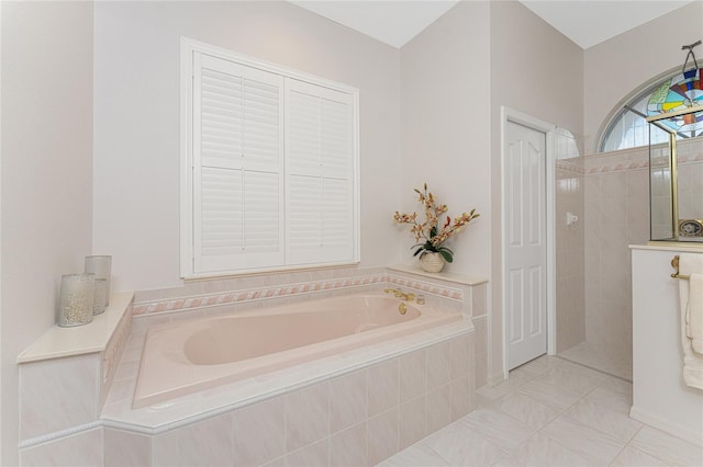 bathroom with independent shower and bath and tile patterned flooring