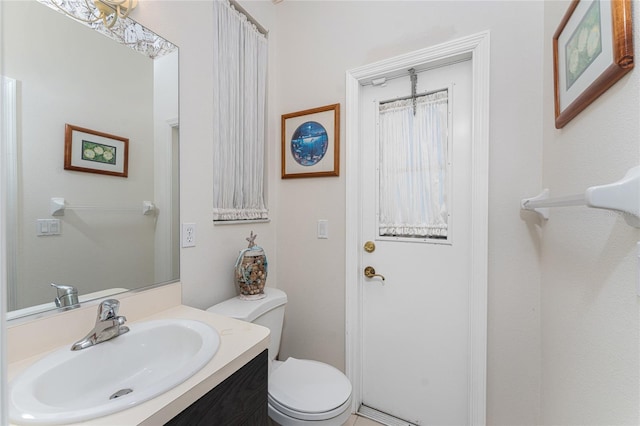 bathroom featuring toilet and vanity