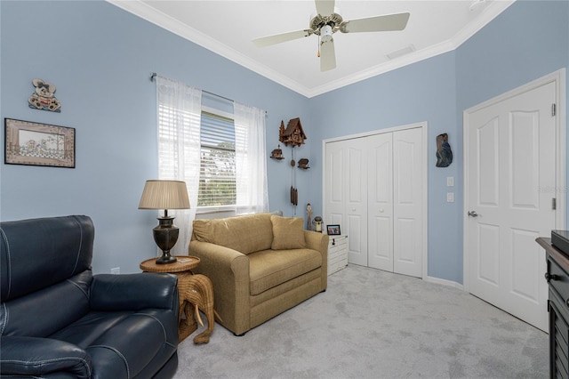 sitting room with ornamental molding, light carpet, and ceiling fan