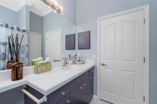 bathroom with vanity, crown molding, and tile patterned flooring