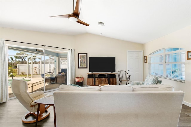 living room with hardwood / wood-style floors, vaulted ceiling, and ceiling fan