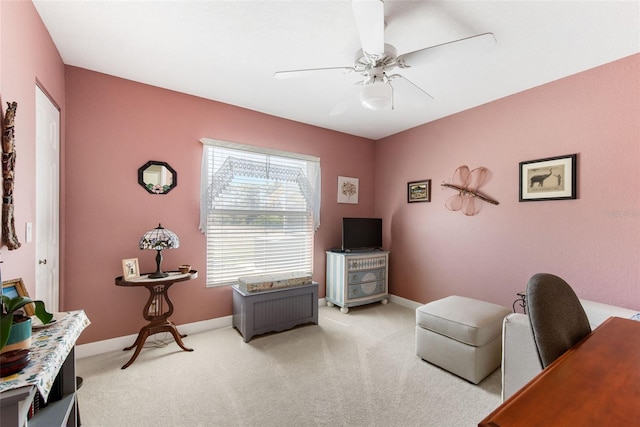 living area featuring ceiling fan and carpet flooring