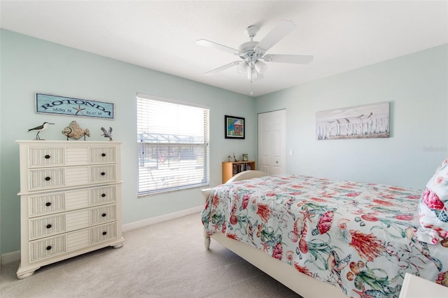 bedroom featuring a closet, ceiling fan, and light carpet