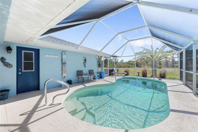 view of swimming pool featuring a patio and glass enclosure