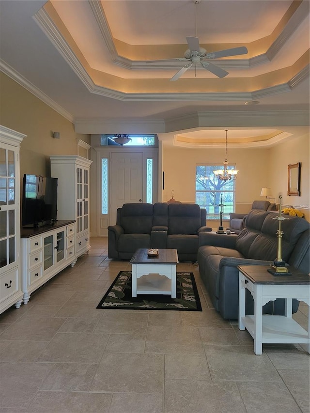 living room featuring ceiling fan with notable chandelier, a raised ceiling, and crown molding