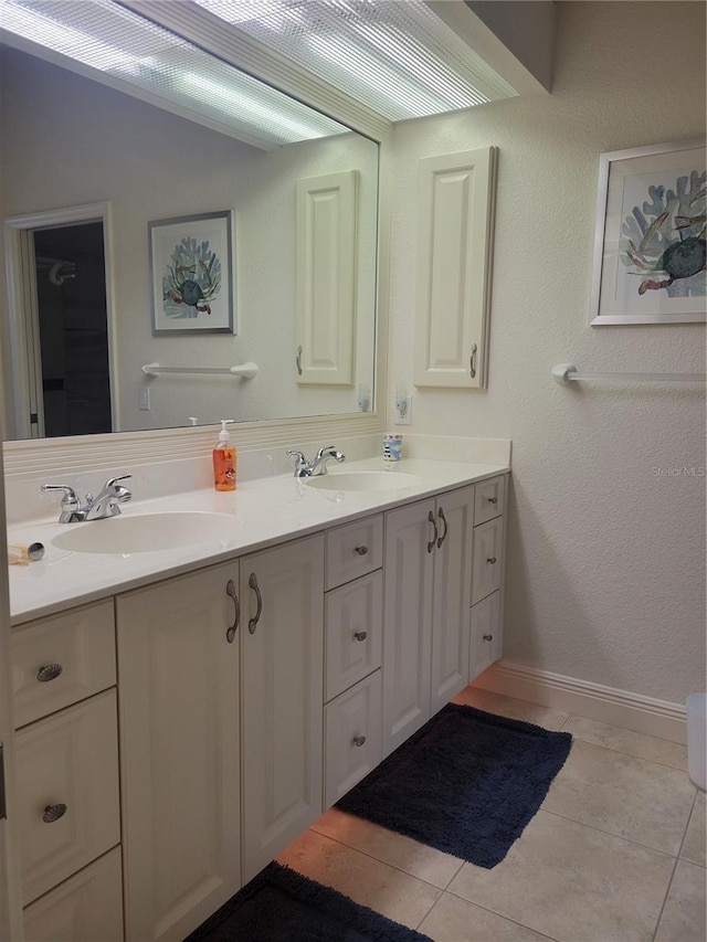 bathroom featuring tile patterned flooring and vanity