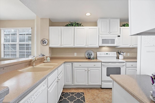 kitchen featuring white cabinetry, white appliances, sink, and light tile patterned floors