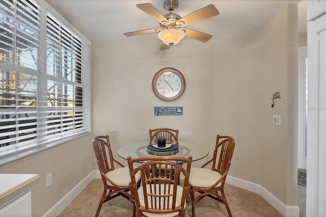 dining area with ceiling fan and light tile patterned flooring