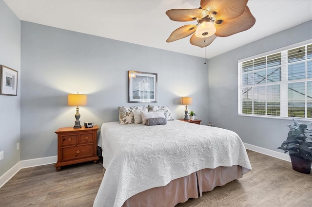 bedroom with hardwood / wood-style floors and ceiling fan