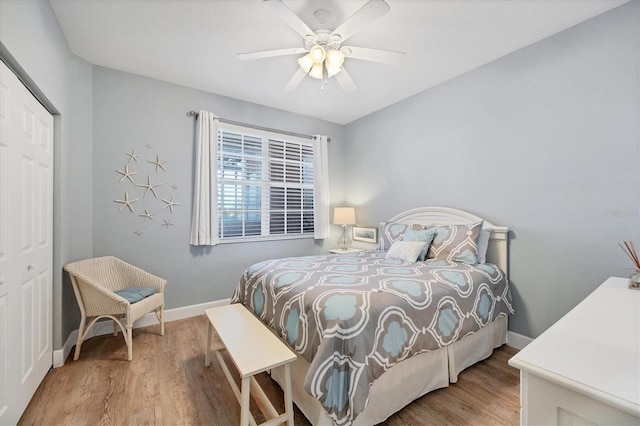 bedroom featuring ceiling fan, a closet, and hardwood / wood-style flooring