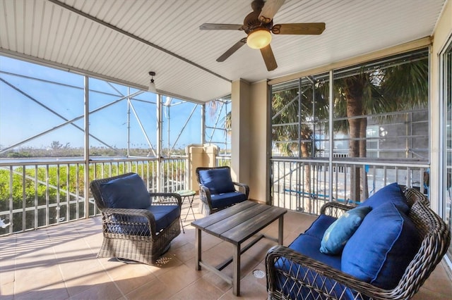 sunroom featuring ceiling fan